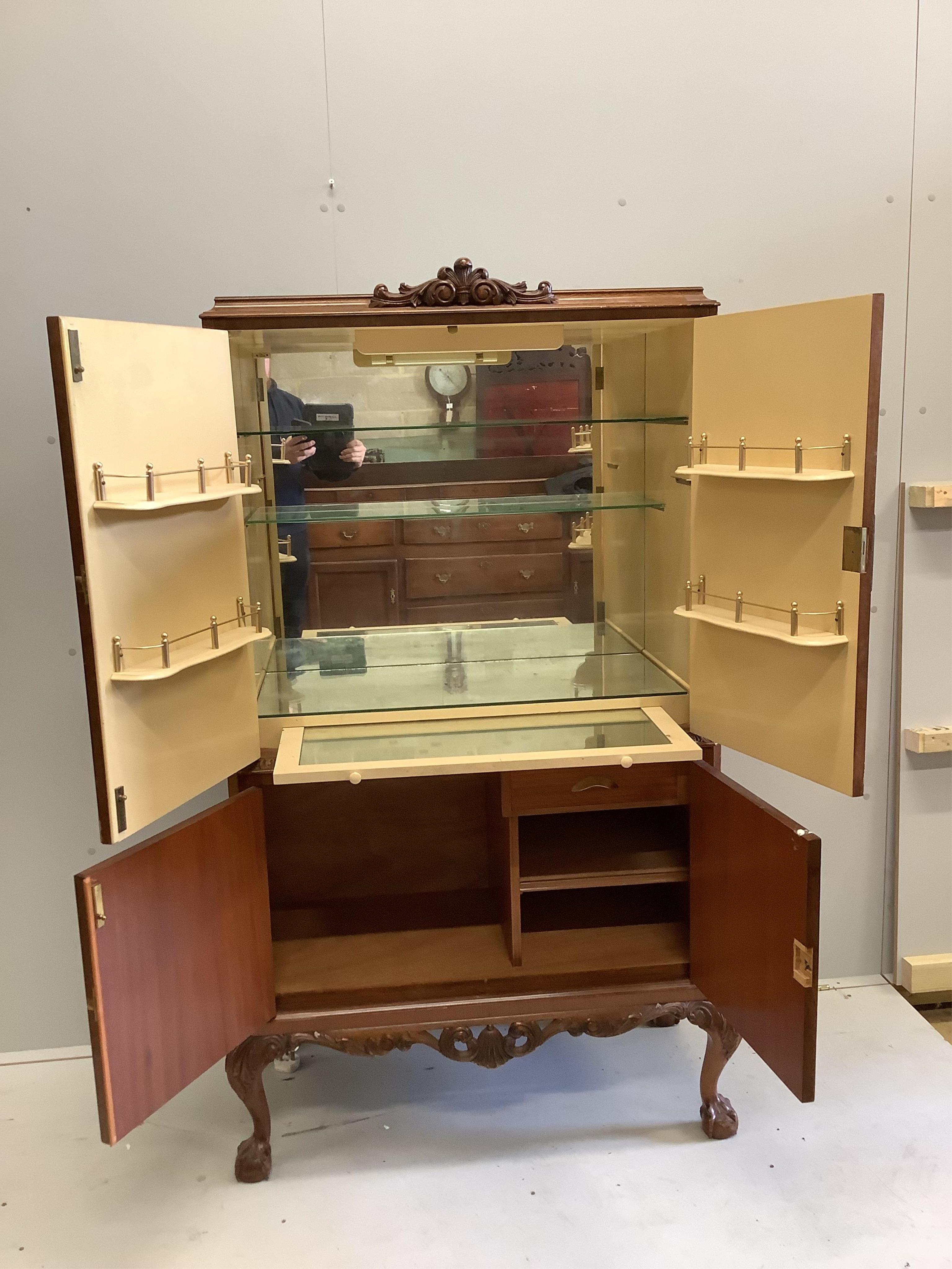 A Queen Anne Revival walnut cocktail cabinet, width 94cm, depth 48cm, height 160cm. Condition - good